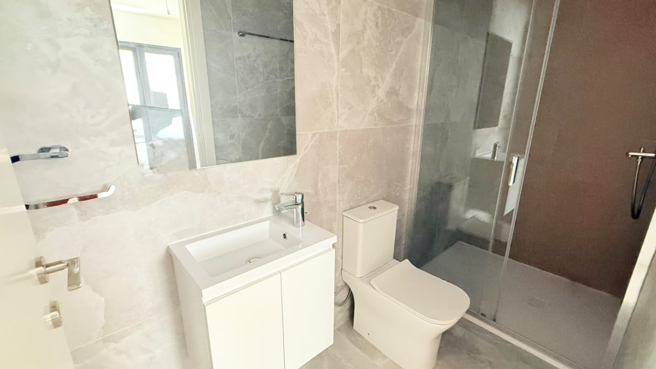Completed VESTA LIVING bathroom with vanity, sanitary ware and glass shower enclosure